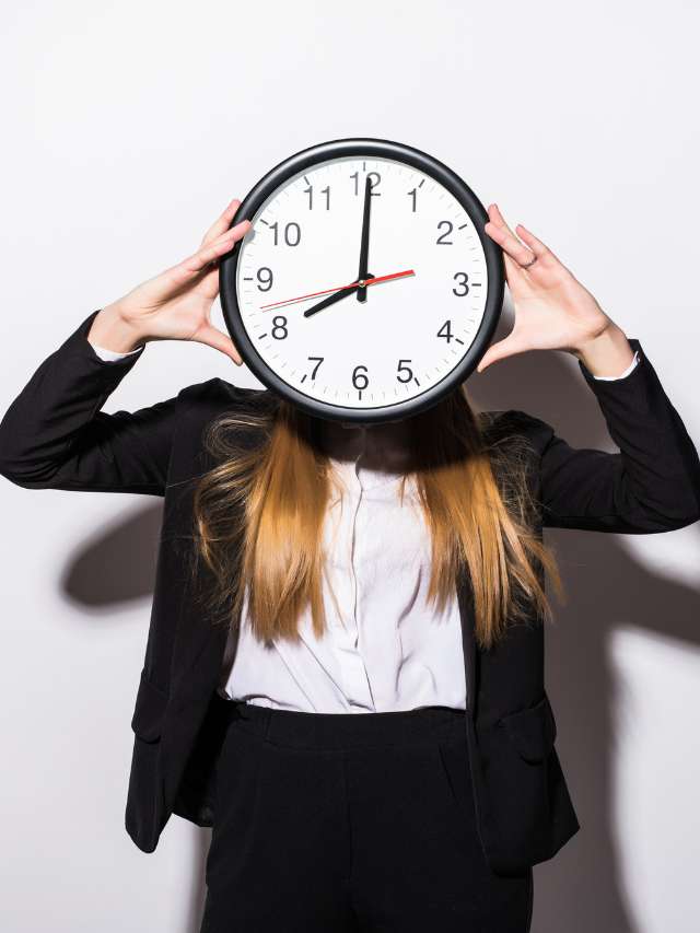 beautiful-young-business-woman-holding-clock-front-face-white